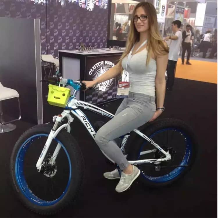rider tests riding of e-bike with brand RICHBIT on exhibition